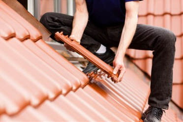 Repairing a tile roof. Reliable Roof Repairs